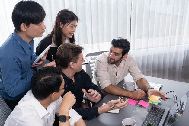 diverse-team-collaborating-and-brainstorming-around-laptop-in-modern-office